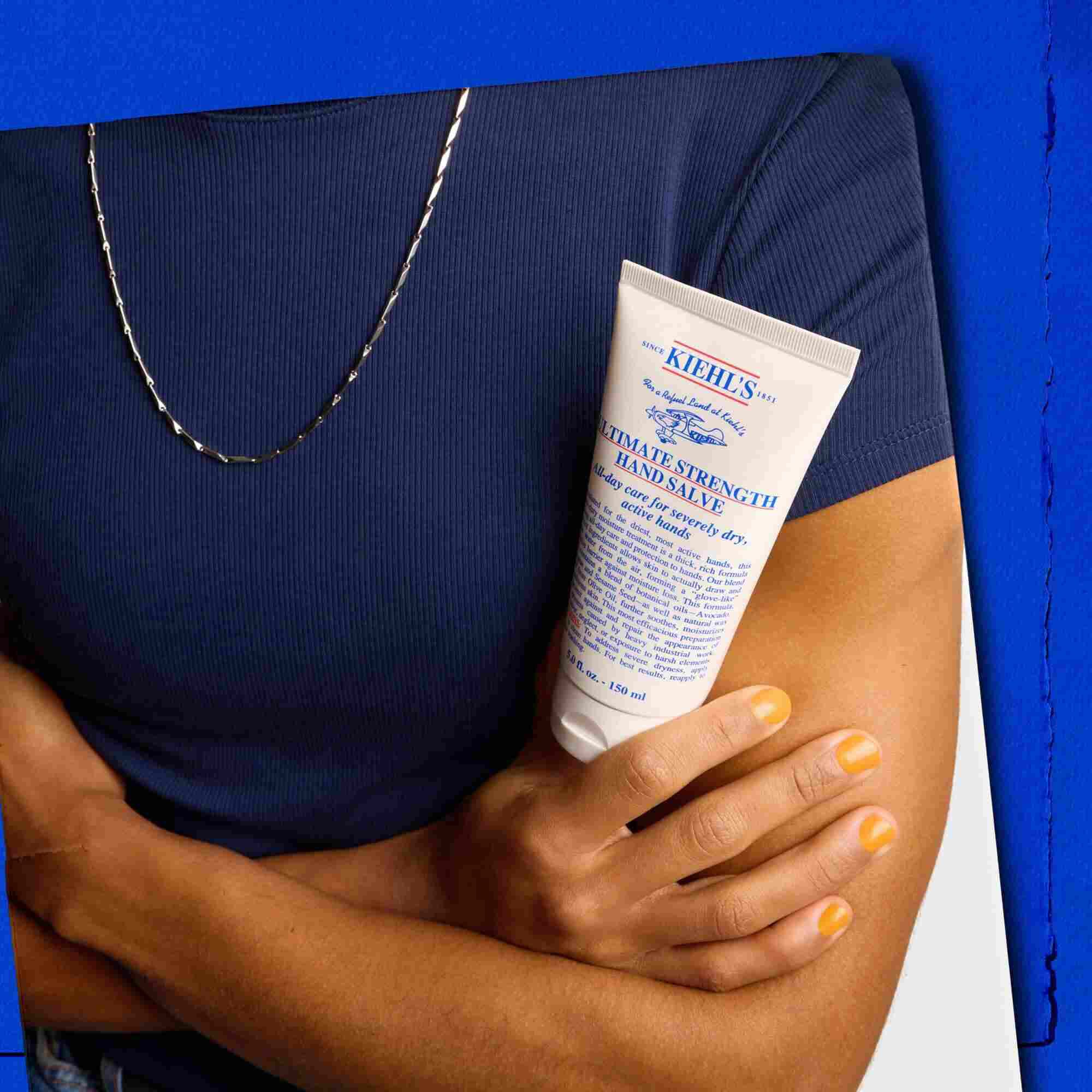 Modelka trzymająca tubkę Kiehl's Ultimate Strength Hand Salve