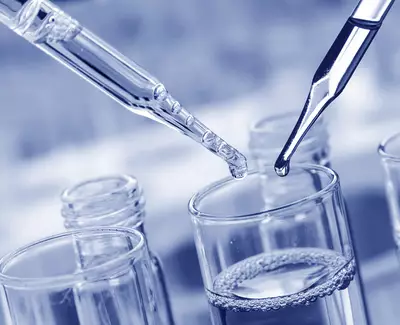 Close-up of two pipettes hovering over a glass with a liquid, surrounded by additional glass containers. The image is tinted in blue tones.