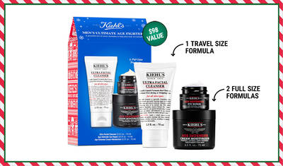 Alt text: A boxed set of Kiehl's Men's Ultimate Age Fighter products, featuring one travel size Ultra Facial Cleanser and two full-size jars of Age Defender Cream Moisturizer, with a highlighted value of $98.