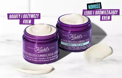 Two jars of Kiehl's Super Multi-Corrective Cream, one labeled "Rich & Nourishing Cream" and the other "New Lightweight Soft Cream," with a creamy texture swirled on the side.
