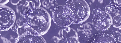 Obrazek przedstawia wiele bąbelkow unoszących się na purpurowym tle.